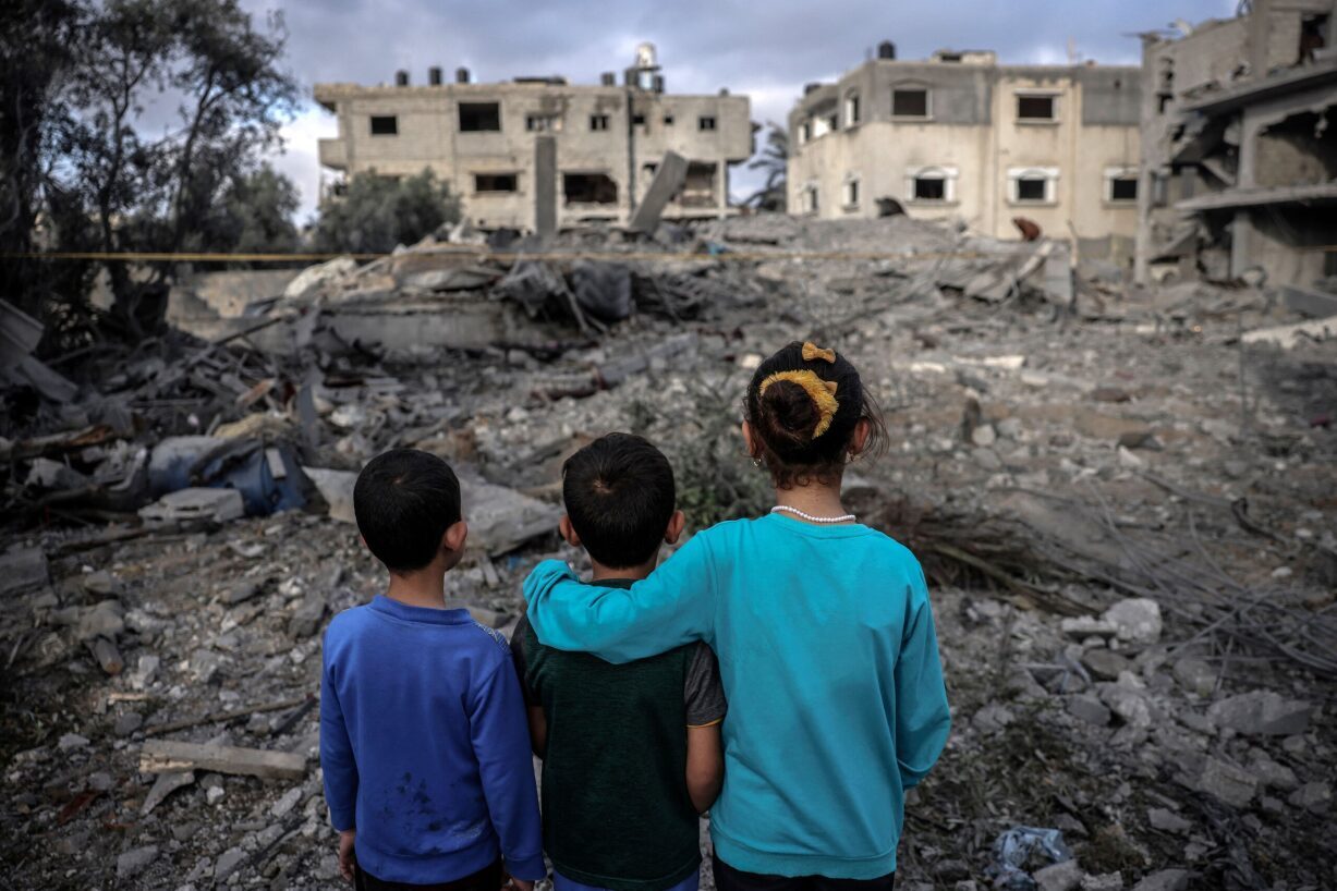 Children looking at rubble